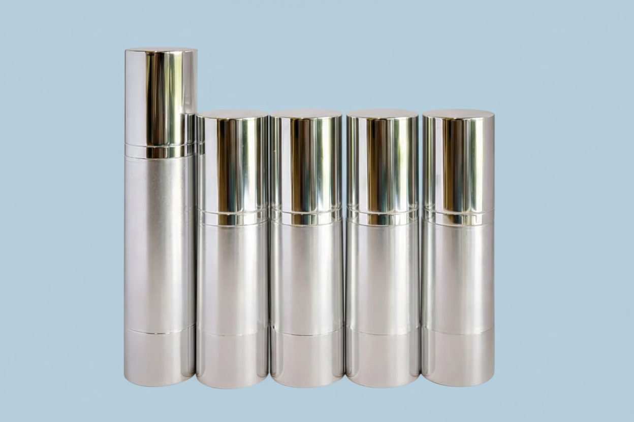Set of silver airless bottles on a white background