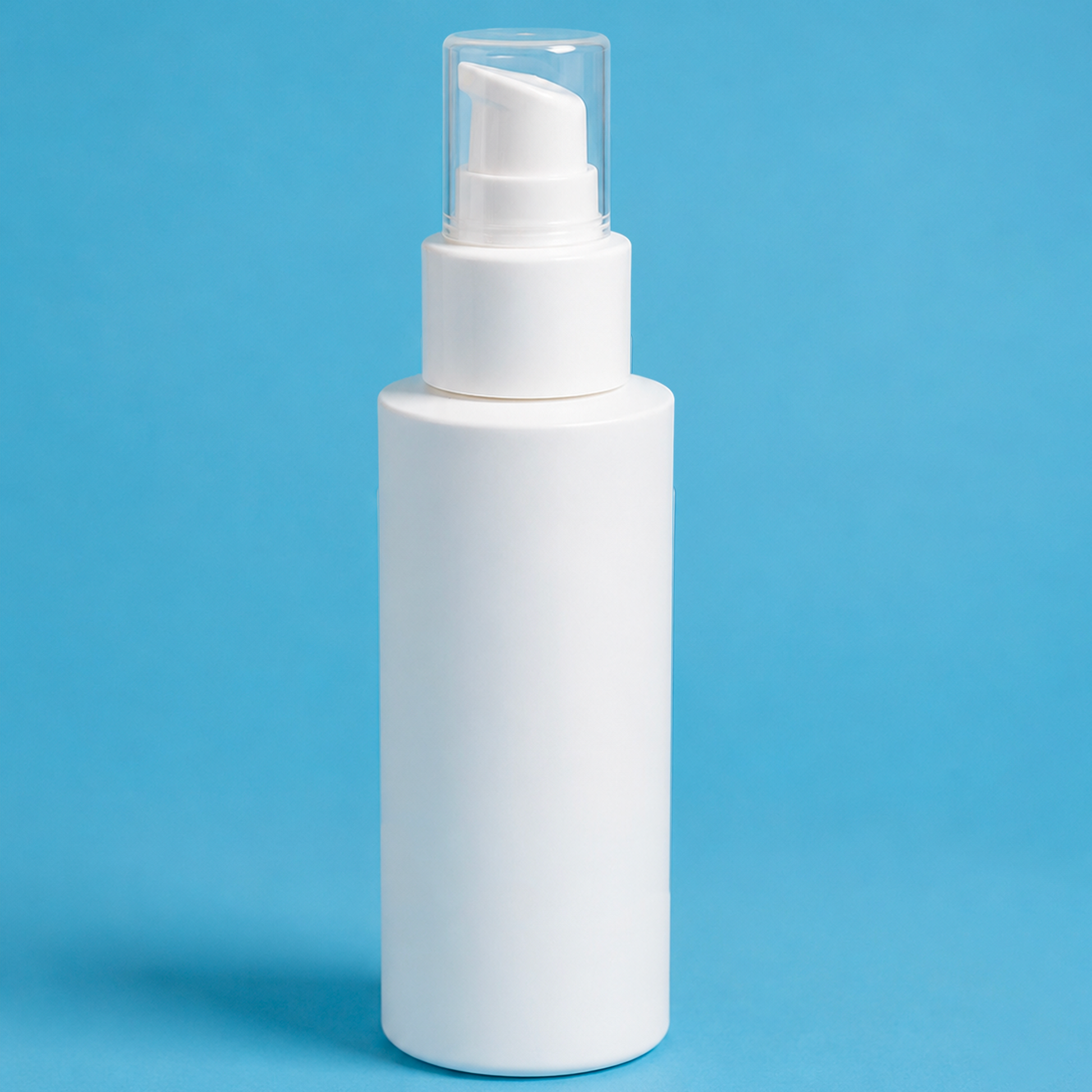 White spray bottle on a blue background